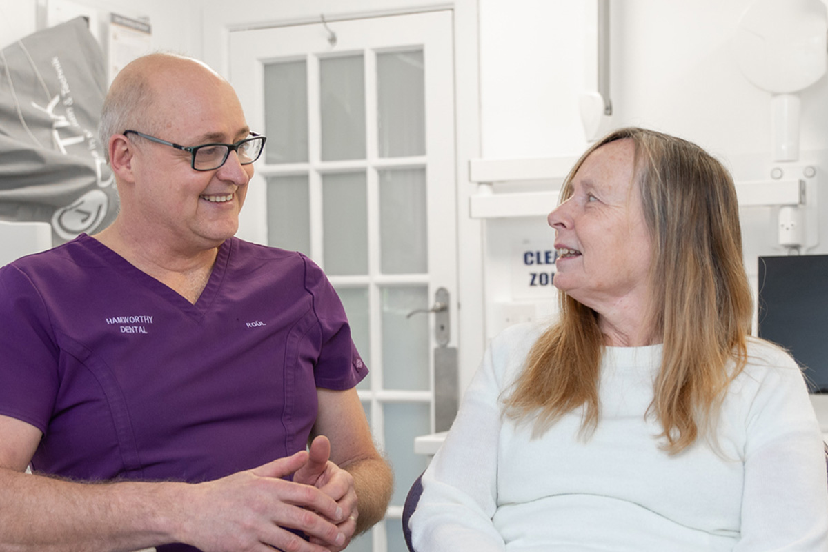 Happy patient looking in a mirror